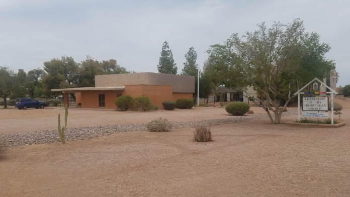 Exterior view of treatment center building with desert landscaping, parking area, and facility signage