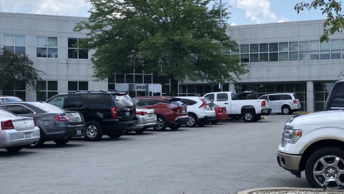 Exterior parking area with multiple vehicles and multi-story treatment facility building numbered 3430 visible.
