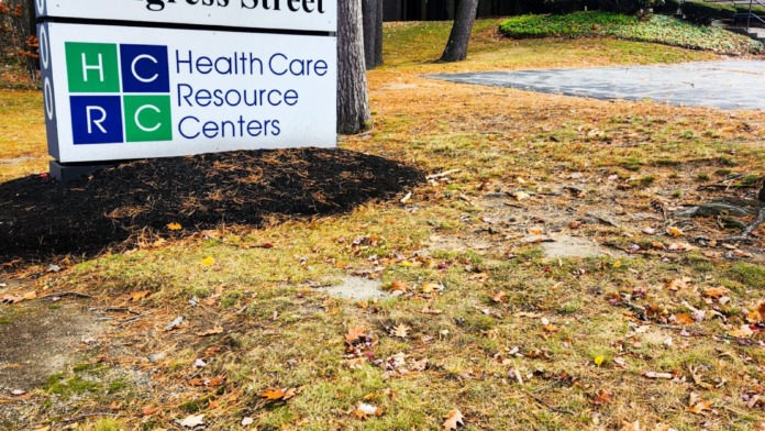 Exterior ground sign displaying 2300 Congress Street address with Health Care Resource Centers logo, landscaping, and building structure visible