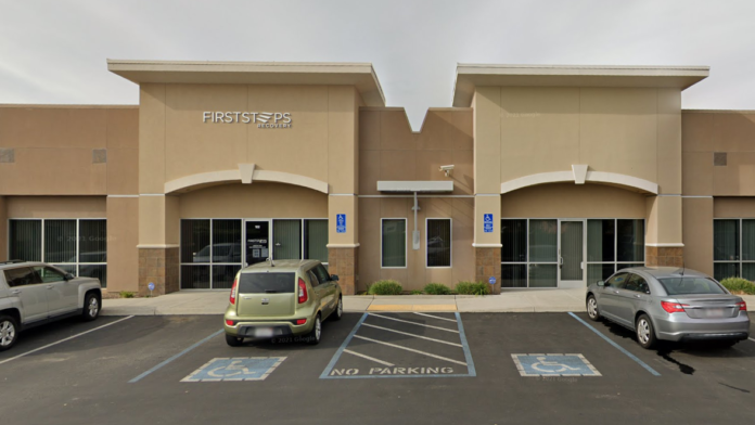 Exterior front facade with First Steps Recovery signage, parking lot with accessible spaces, and entrance doors