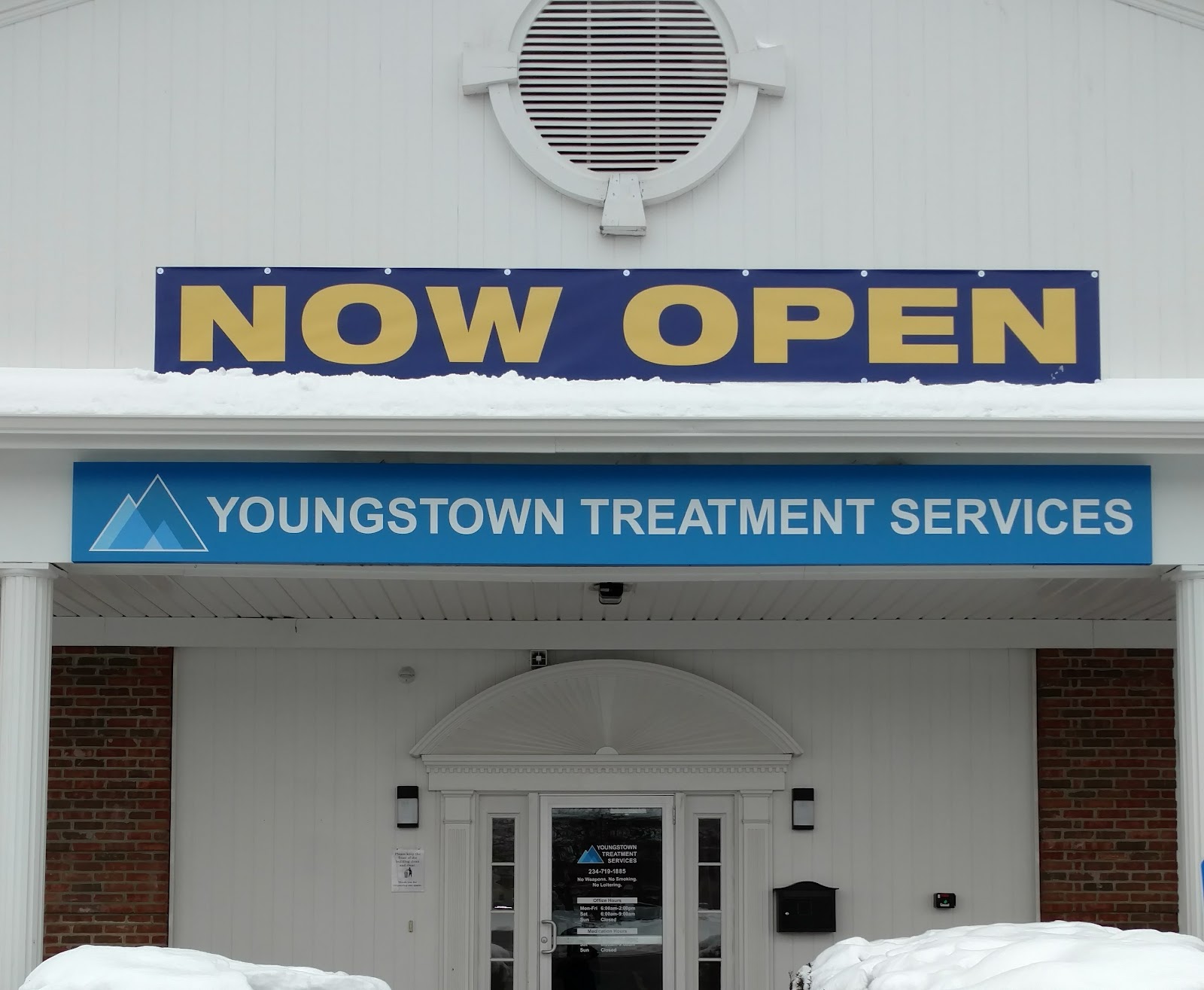 Exterior front view showing NOW OPEN banner and Youngstown Treatment Services signage with entrance