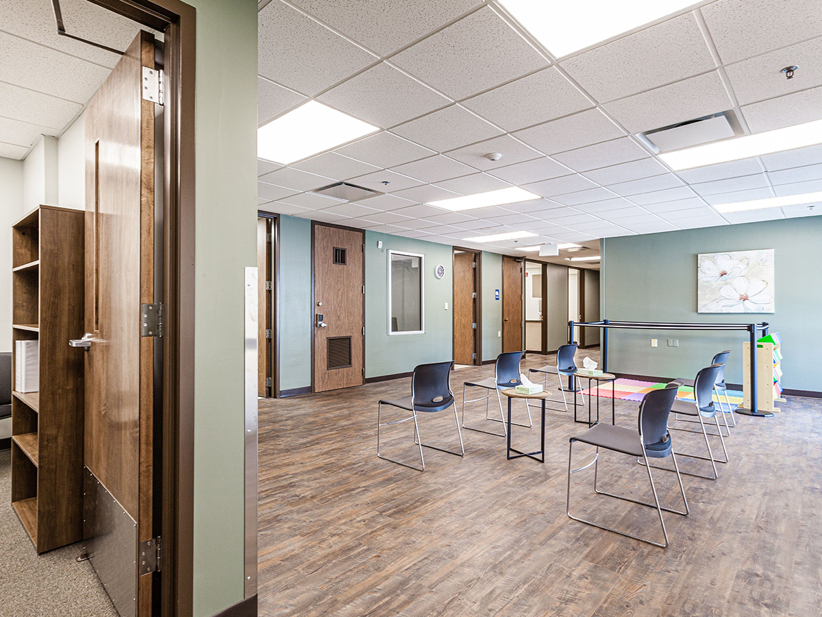 Interior open room with multiple chairs arranged in circular configuration for group sessions and activities