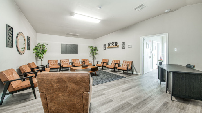 Interior common space with multiple seating areas, therapy room setup with leather chairs arranged for group sessions