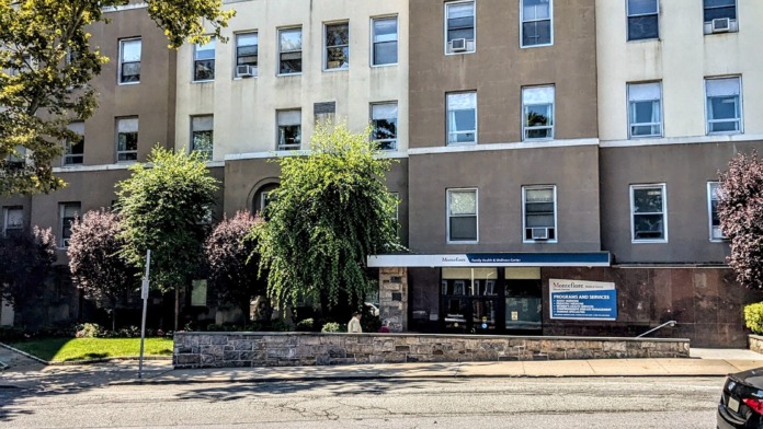 Exterior multi-story brick hospital building with Montefiore signage and regular window pattern across four stories