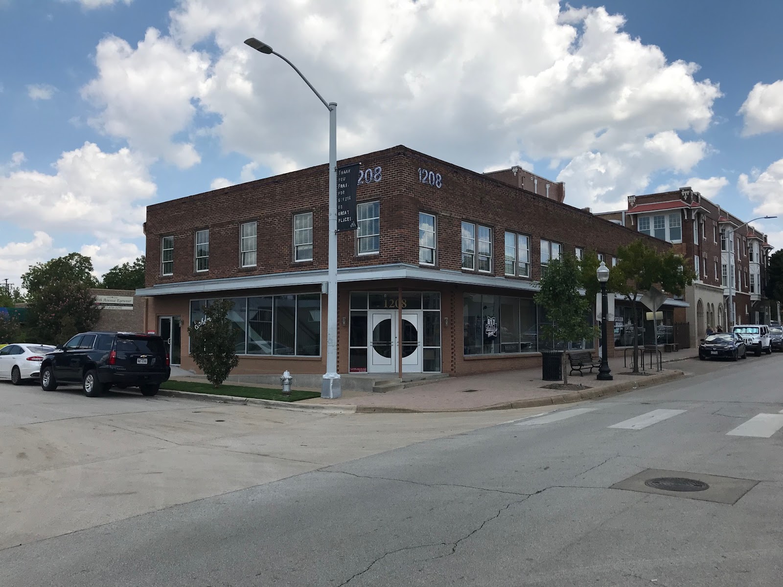 Exterior corner view of two-story brick treatment center building with storefront windows and entrance doors