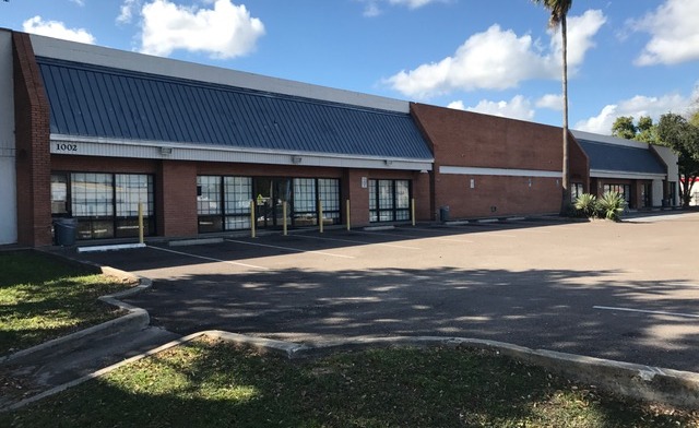Exterior view of brick treatment facility with metal roof, large front windows, and parking lot