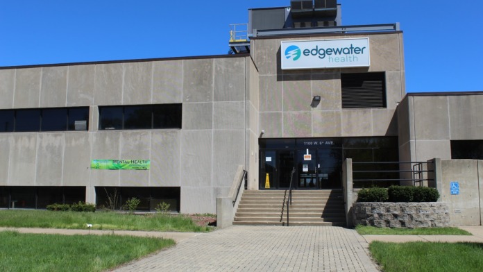 Exterior view of Edgewater Health treatment center showing main entrance, concrete facade, and facility signage at 1100 West 6th Avenue