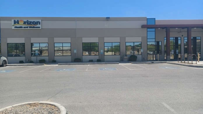 Exterior view of Horizon Health and Wellness facility showing main entrance with storefront windows, signage, and parking area