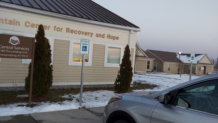 Exterior view of Mountain Center for Recovery and Hope main entrance with signage, accessible parking, and snow-covered grounds