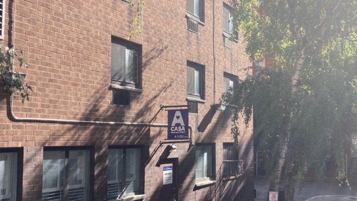 Exterior brick building showing ground-floor entrance with CASA signage and facility identification.