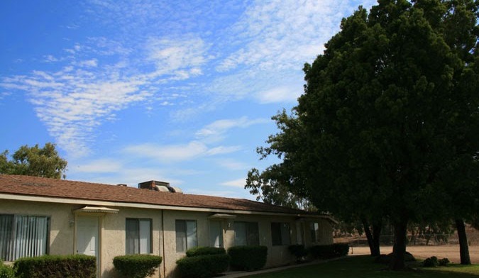 Exterior view of main treatment facility building with landscaping, trees, and outdoor grounds