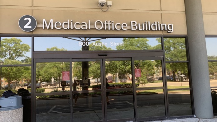 Interior building entrance showing directional signage for Medical Office Building at 800 Austin Street with glass doors