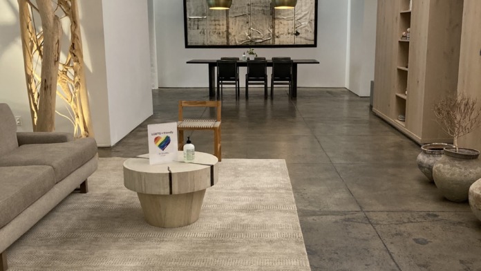 Interior meditation space with cushioned floor seating, wooden structural elements, and calm natural lighting