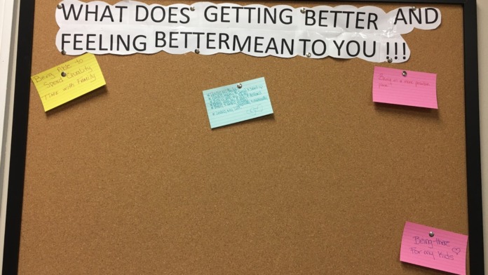 Interior bulletin board with inspirational question and colorful sticky note responses from staff or clients.