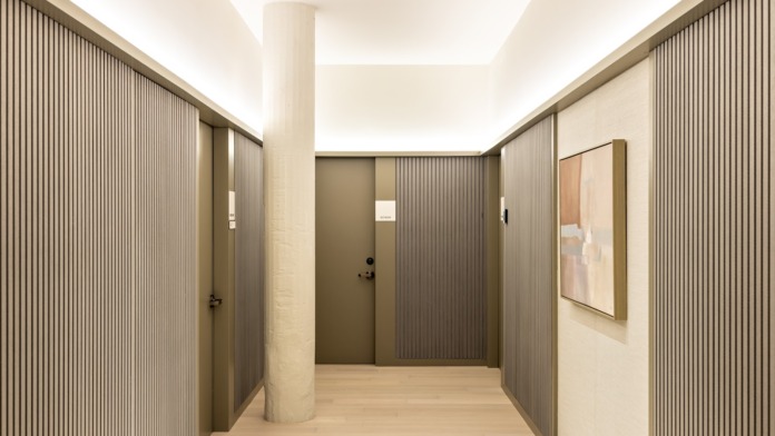 Interior gathering space with contemporary furniture, art displays, and designated activity zones for residents