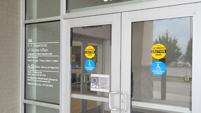 Interior clinic check-in space with glass windows, reception desk, and professional furnishings