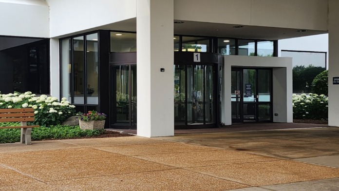 Exterior covered entrance area with modern architectural design, large windows, and accessible patient drop-off