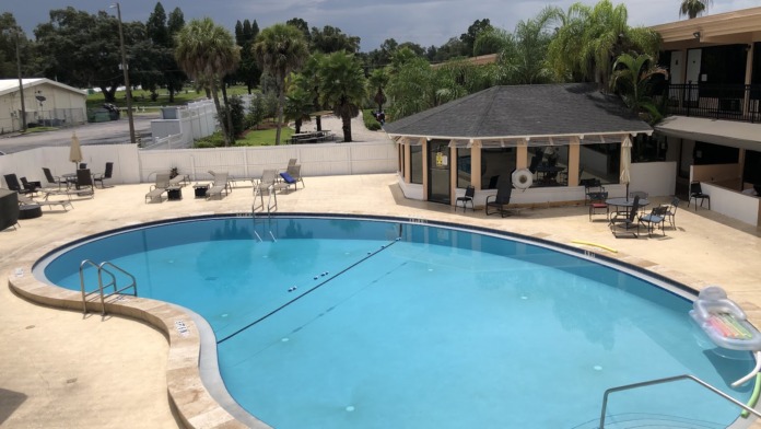 Outdoor swimming pool with lounge seating and landscaped grounds surrounding the facility