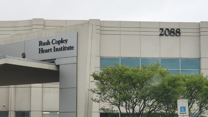Exterior view of specialized cardiac care facility entrance with signage, address number 2088, and accessible parking