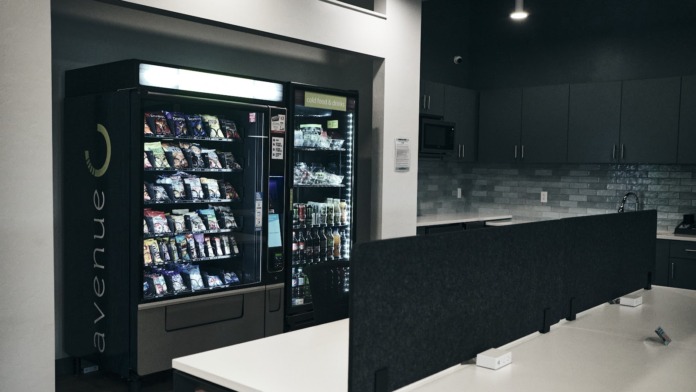Interior snack station featuring vending machines and beverage dispensers with modern countertop and service area