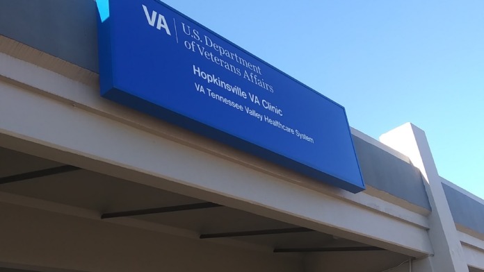 Close-up of blue VA Department of Veterans Affairs signage on clinic building exterior