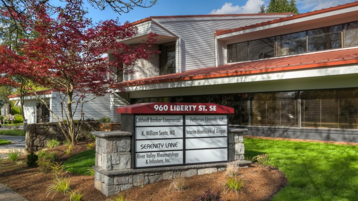 Exterior of treatment facility showing two-story building with signage, landscaping, and main entrance at 960 Liberty Street Southeast.