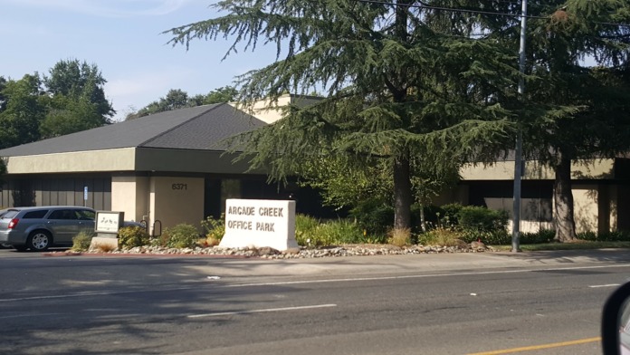Exterior view of treatment center building with signage, parking area, and landscaping