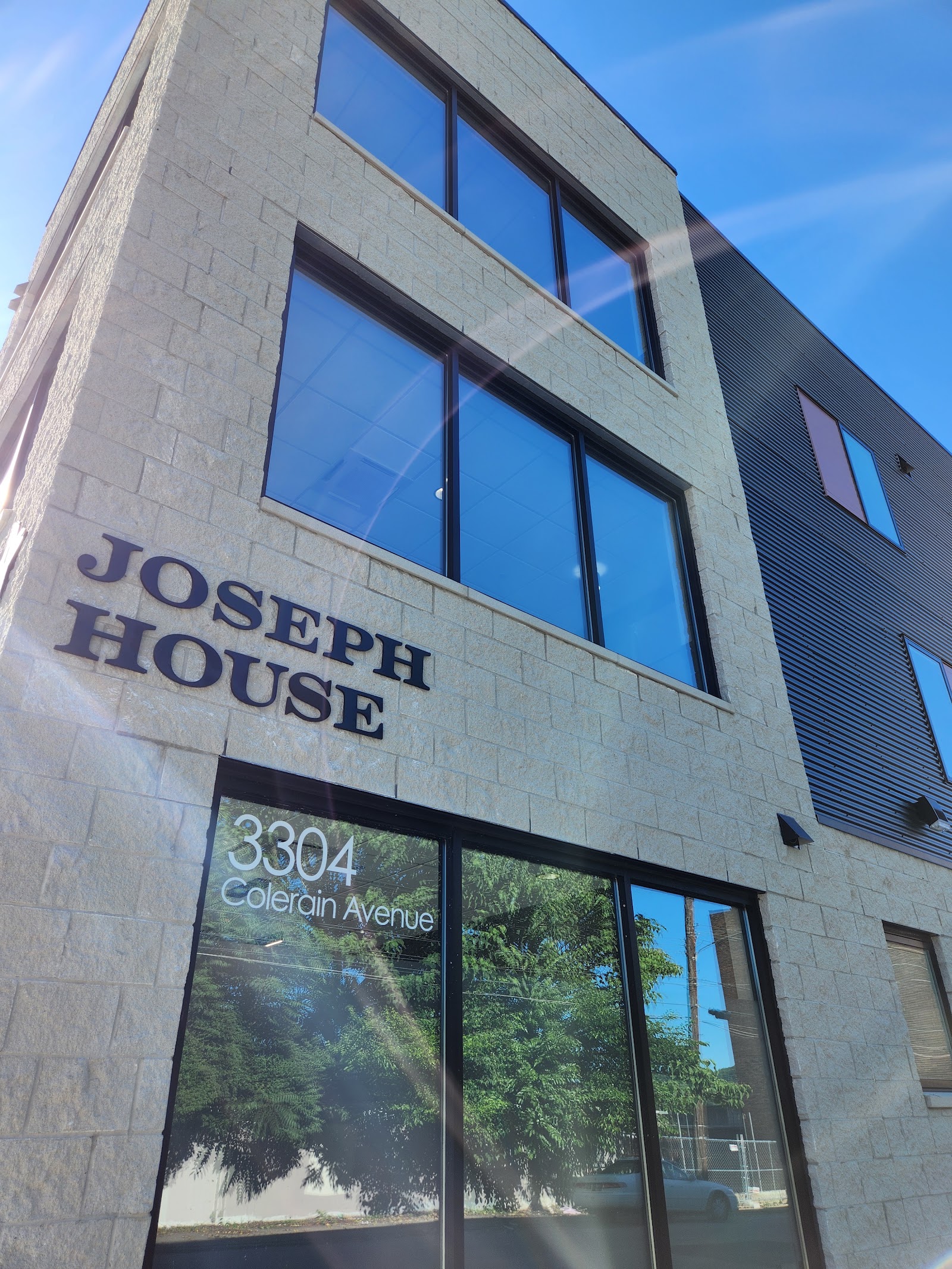 Exterior corner of Joseph House showing facility name, street address 3304 Colerain Avenue, modern stone and metal facade