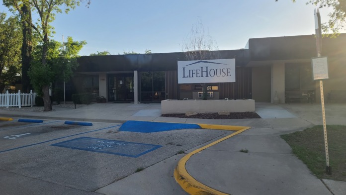 Exterior modern black metal building with LifeHouse entrance, landscaping, and parking lot markings visible.