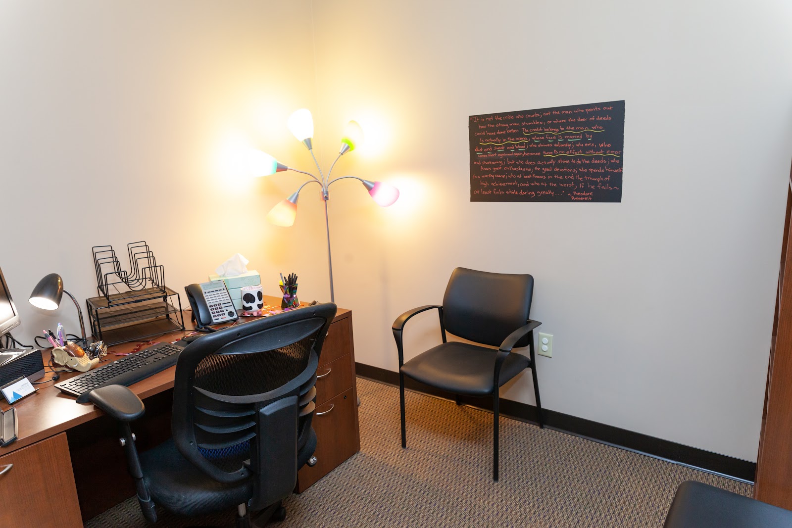 Interior office with desk, computer, office chair, lamp, and organized work area with neutral decor