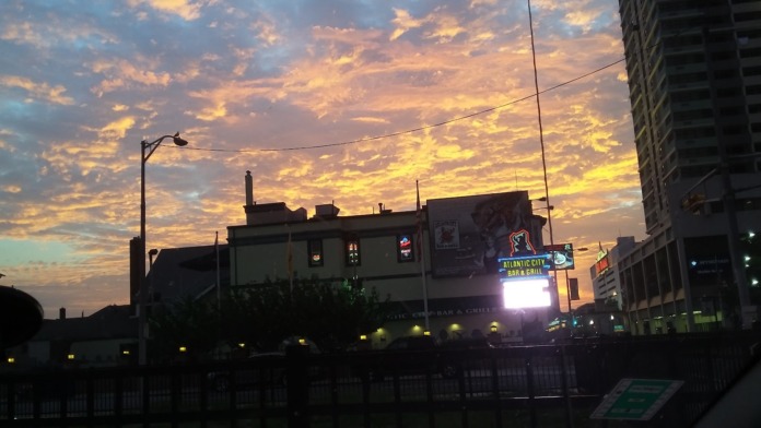 Exterior street view showing urban building facade with signage and street lighting at sunset