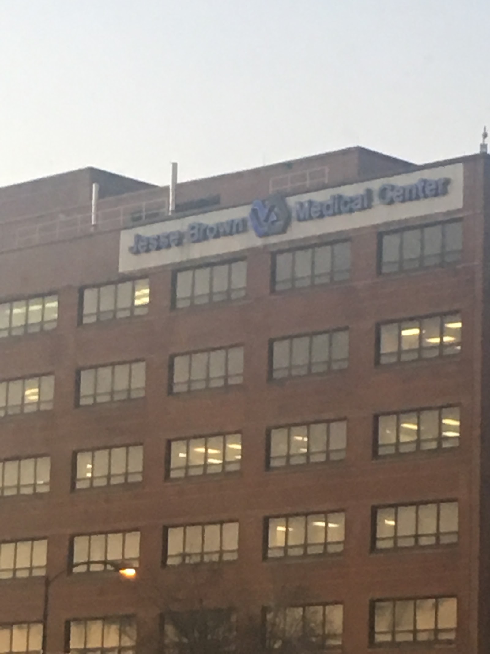 Exterior of Jesse Brown Medical Center building showing brick facade with illuminated windows at evening