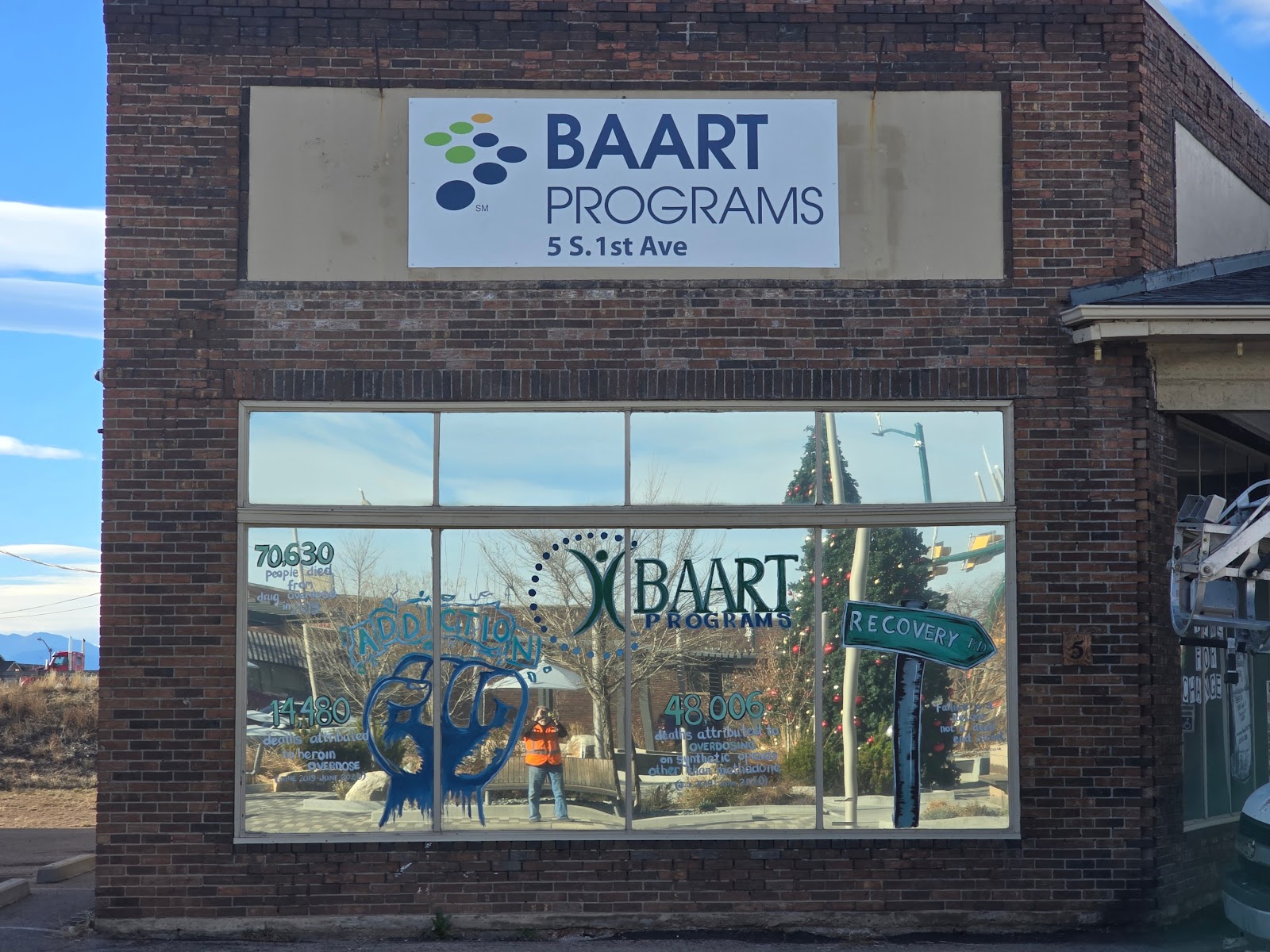 Exterior brick wall with BAART Programs logo sign, address 5 S 1st Ave, facility window signage
