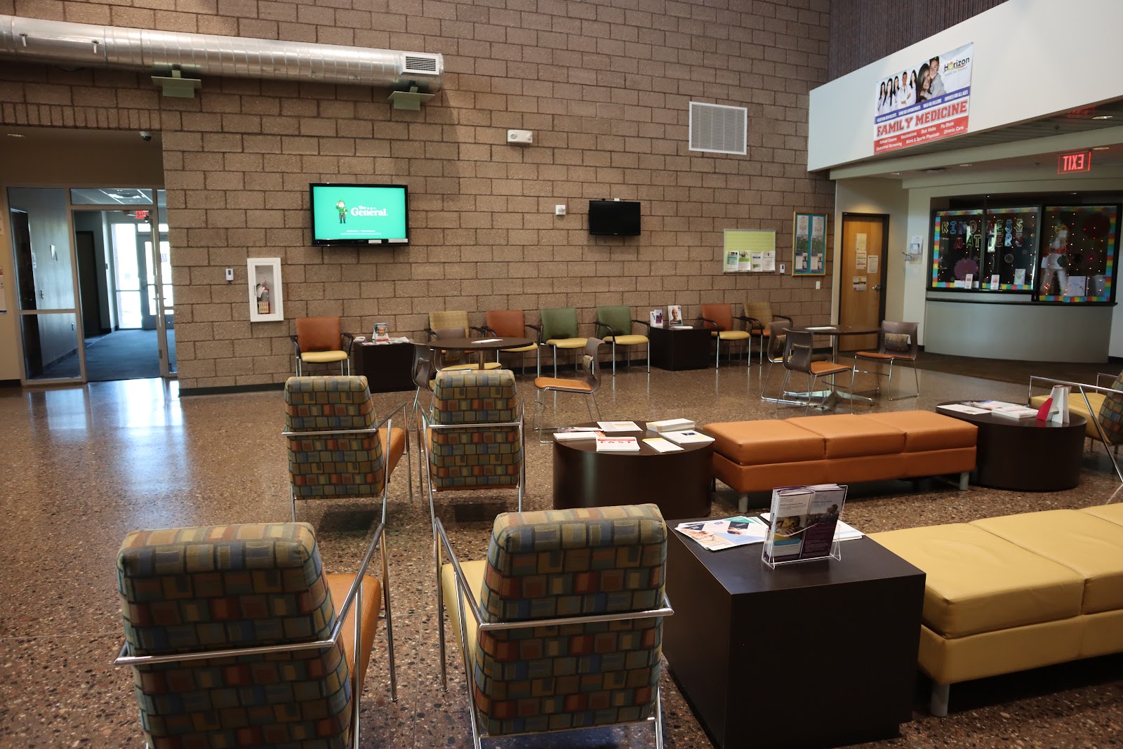 Interior common area with comfortable seating, television display, and informational wall displays