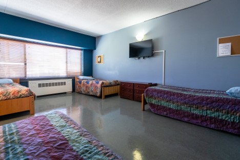 Interior therapy space with educational displays, multiple activity stations, and natural lighting for group therapeutic programs