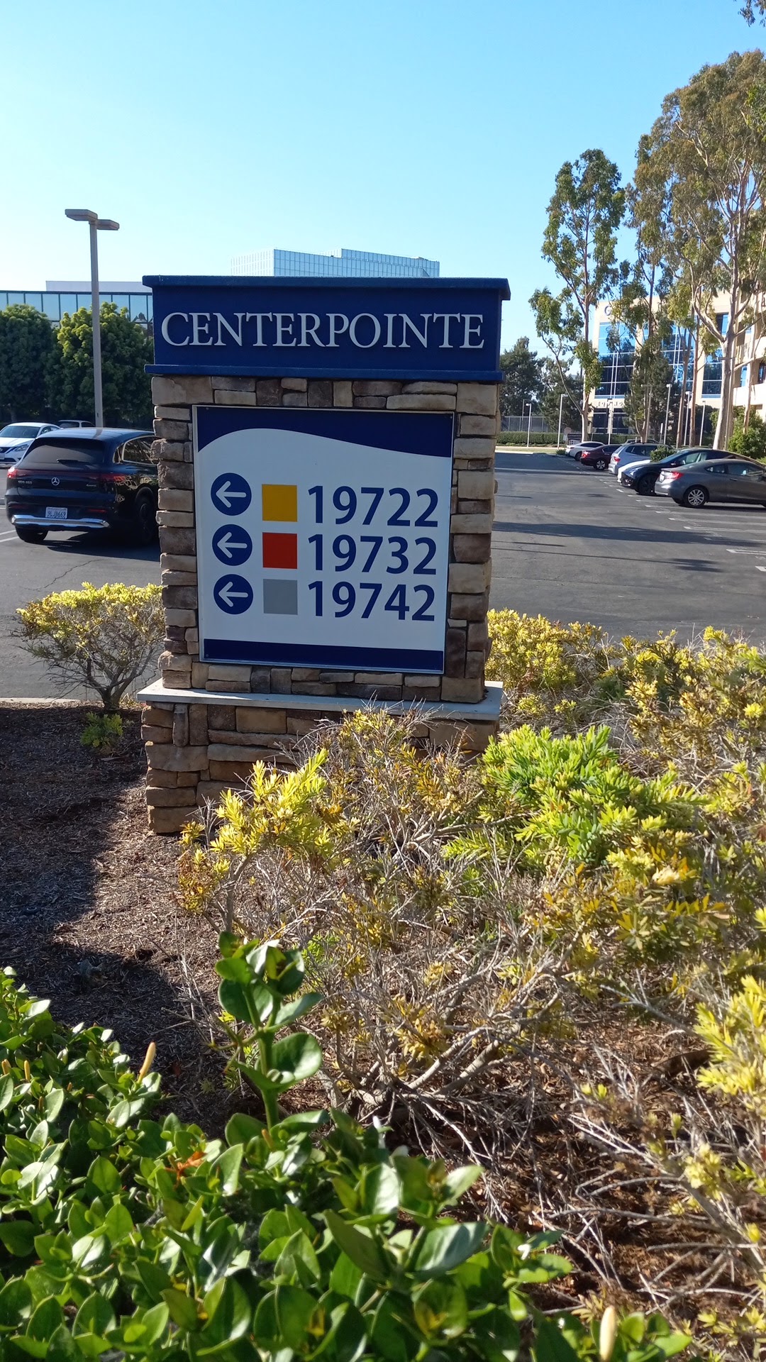 Exterior Centerpointe complex directory sign displaying suite numbers including 19742 with landscaping in foreground