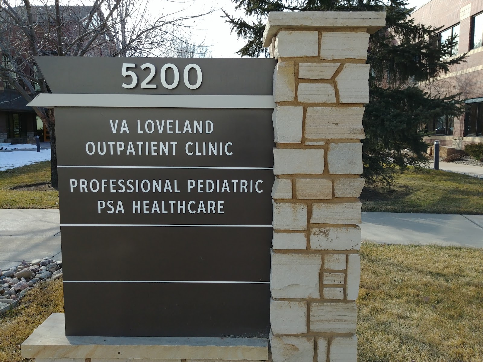 Exterior signage showing facility address 5200 with VA Loveland Outpatient Clinic and Professional Pediatric PSA Healthcare identification