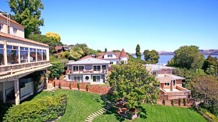 Exterior view of treatment facility with manicured lawn, Spanish-style architecture, and palm trees