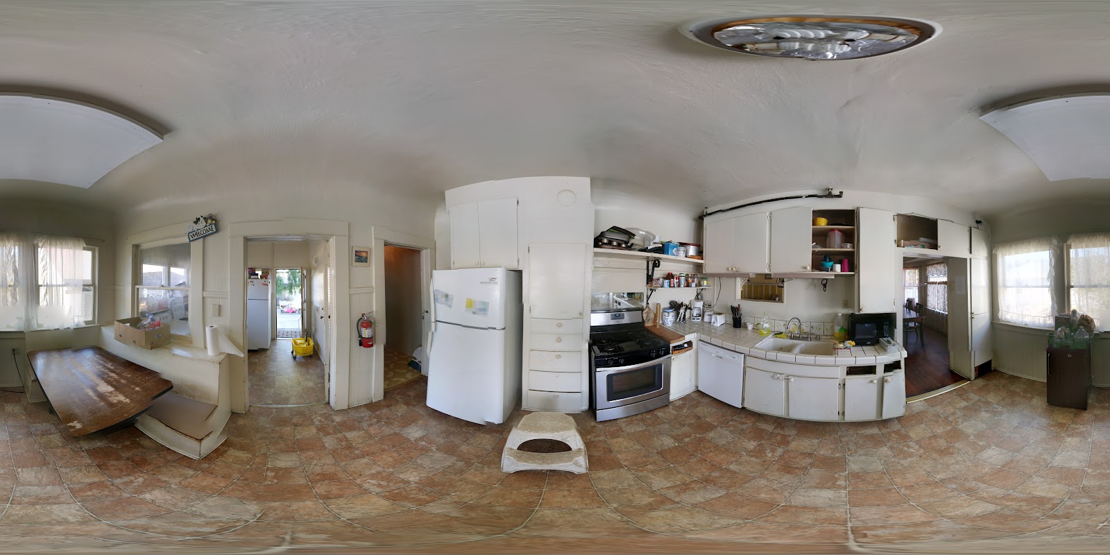 Interior kitchen with white appliances, cabinetry, stove, refrigerator, and countertop workspace