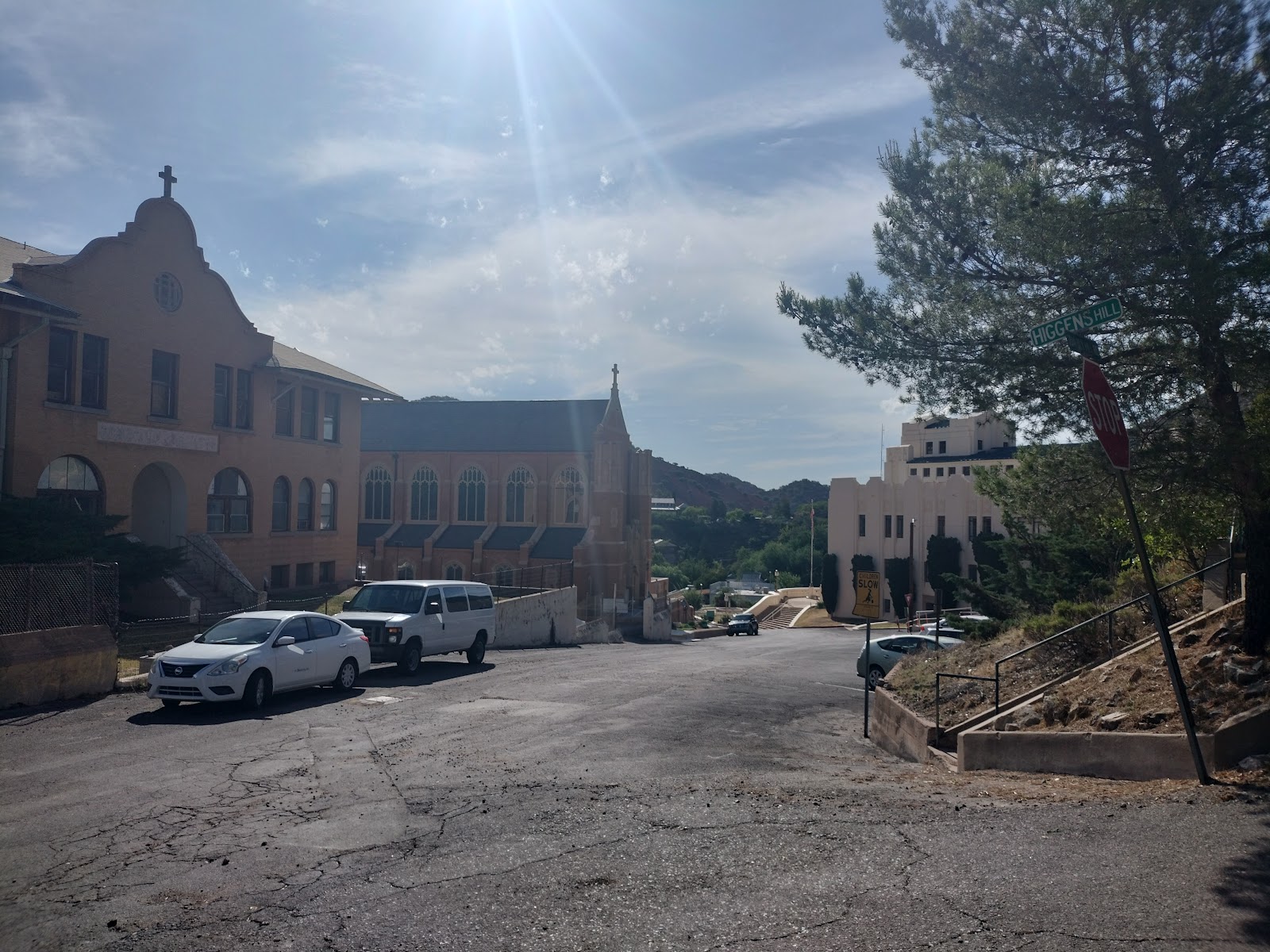 Exterior view of treatment facility showing multi-story buildings, parking area, and surrounding mountainous landscape.