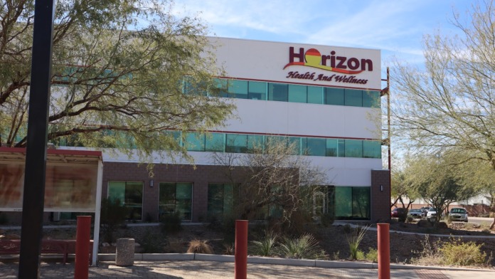 Exterior front view of Horizon Health and Wellness facility showing main entrance with sign and landscaped grounds