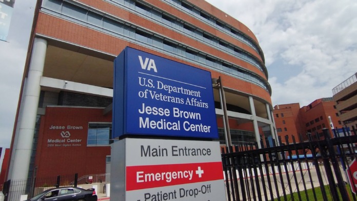 Exterior view of Jesse Brown VA Medical Center main entrance with directional signage, landscaping, and modern building facade
