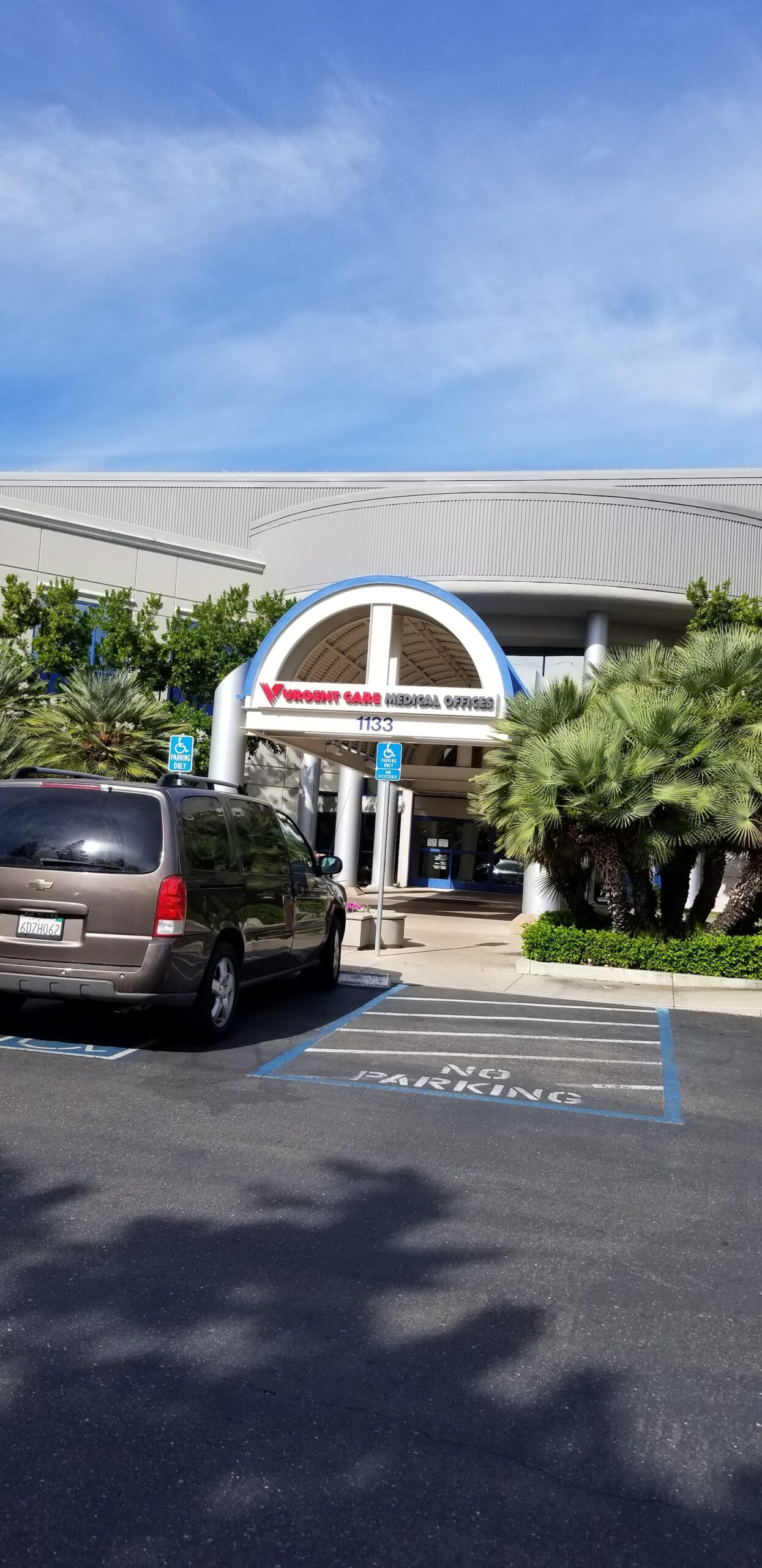 Exterior of ValleyCare facility entrance with curved architectural design and accessible parking spaces