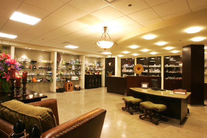 Interior retail area with multiple product shelves, decorative lighting, comfortable seating, and service counter