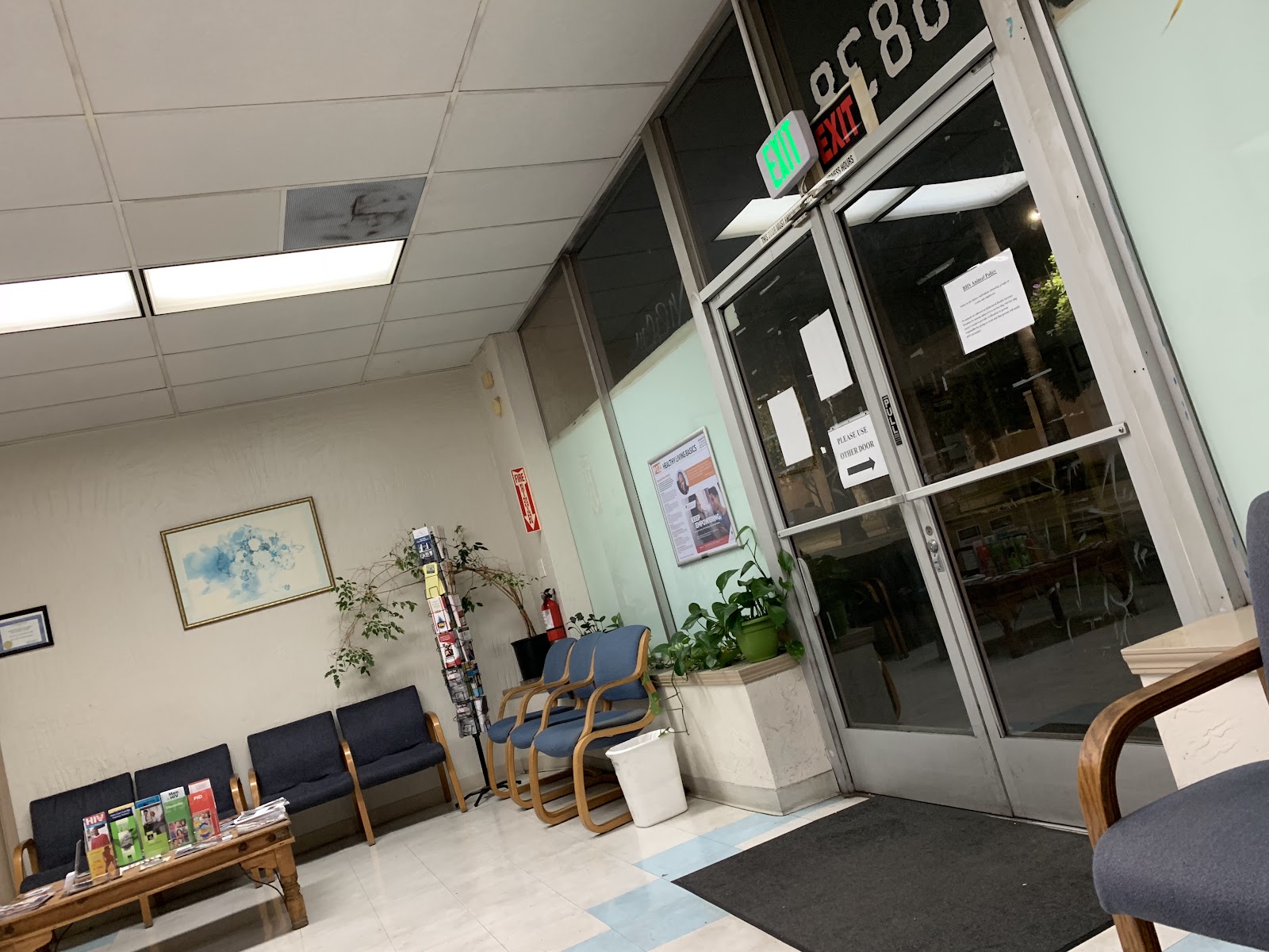 Interior view showing reception desk area with multiple framed certifications and credentials displayed on wall