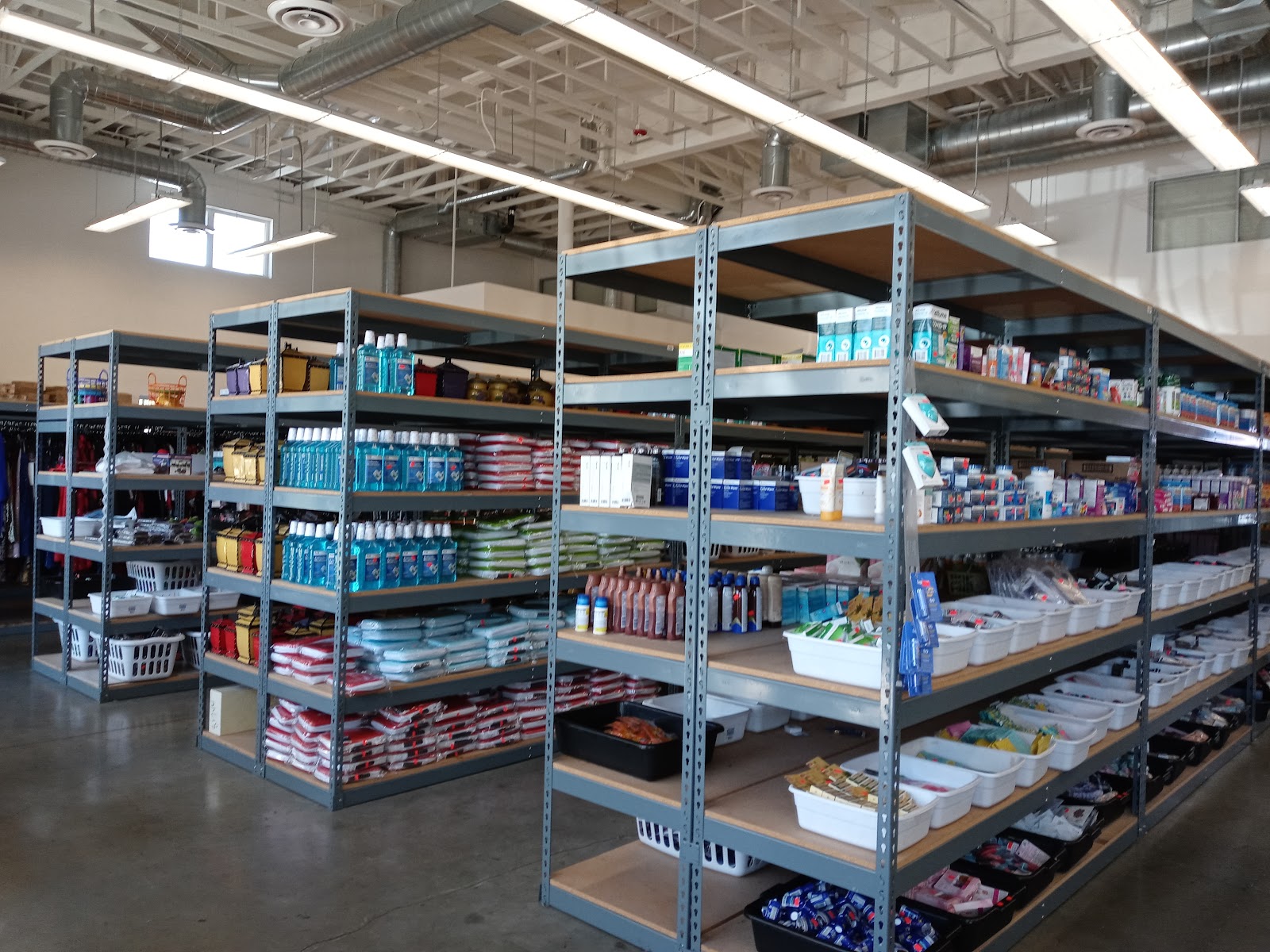 Interior warehouse with industrial shelving units containing packaged supplies and items