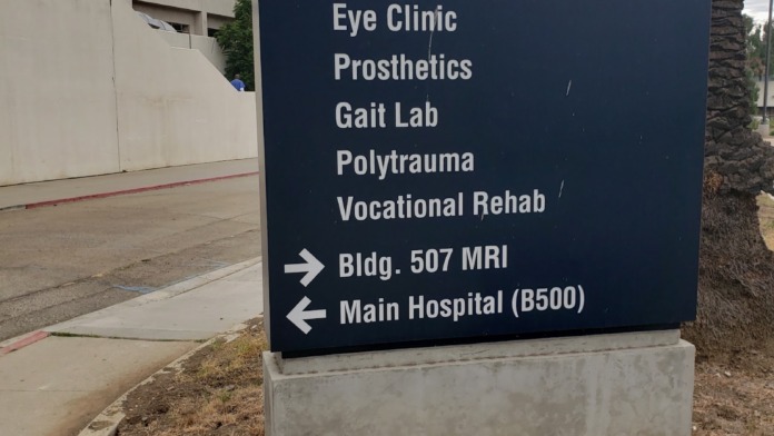 Exterior signage for VA Medical Center showing building directories and clinical service locations