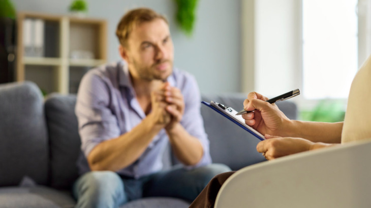 A man speaks with a therapist. Learn more about drug and alcohol addiction therapy, here.